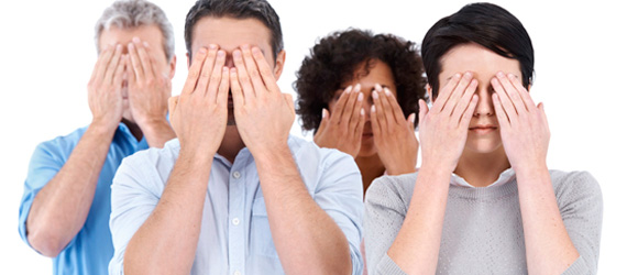 group of business people shielding their eyes