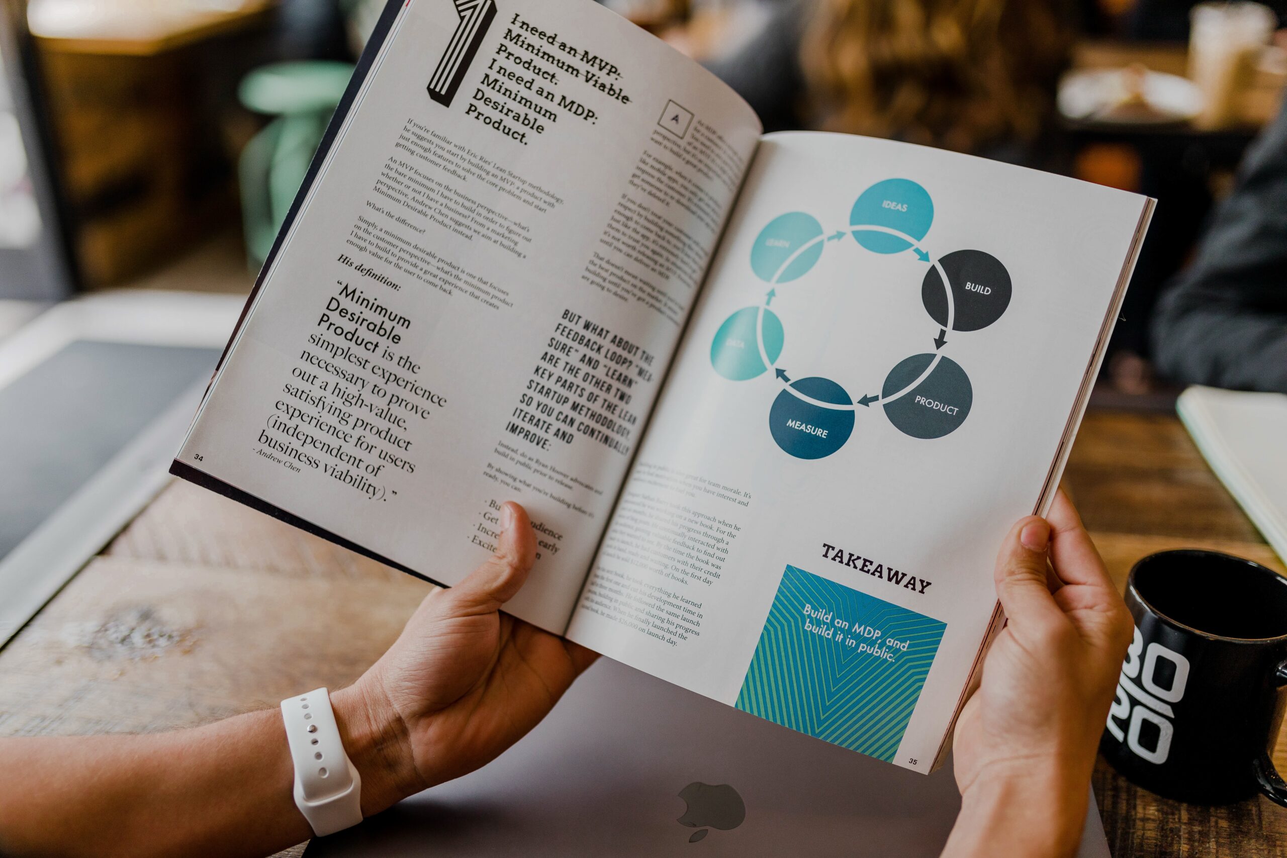 hands holding an informative book with infographics