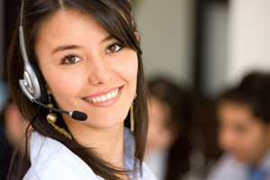 female call center agent with headset and others in background