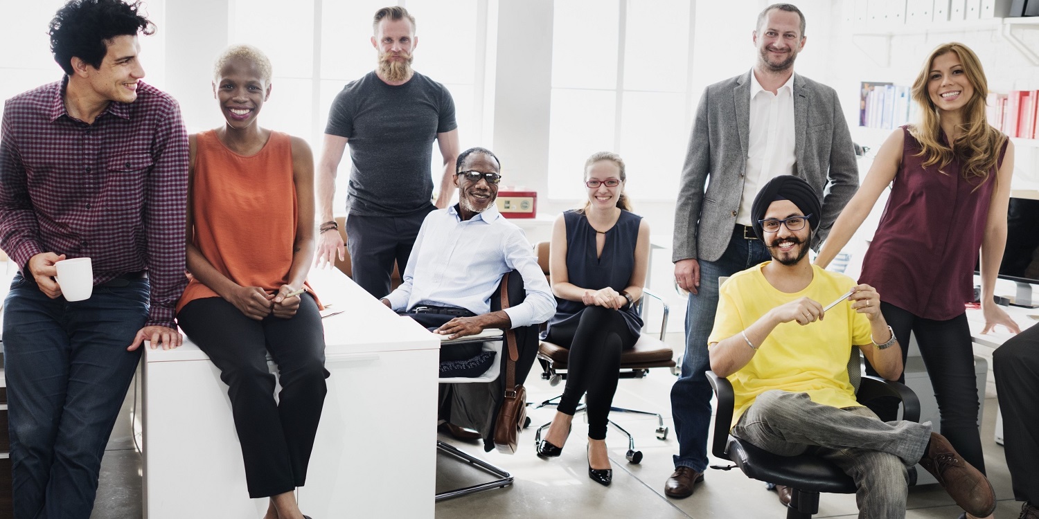 diverse group of business people huddled together in an office