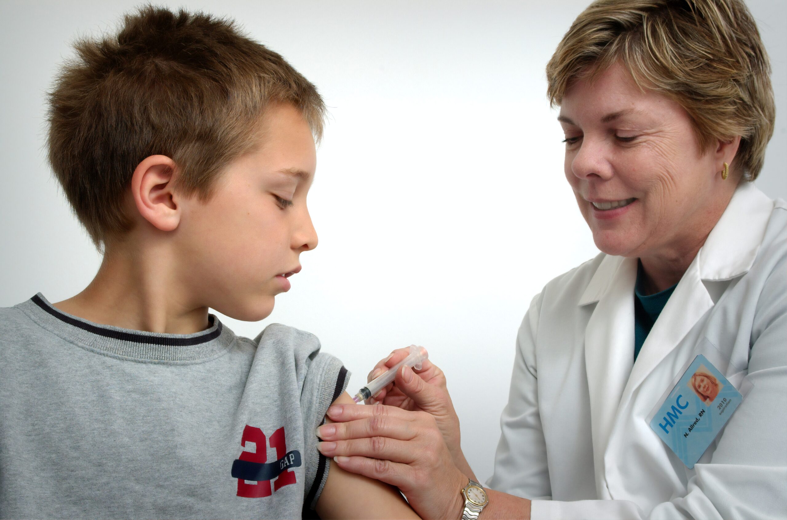 doctor giving child a shot - medical answering services