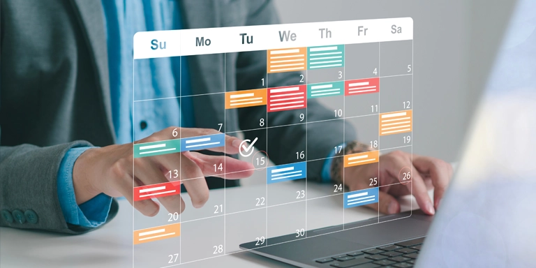 man at a computer with a graphic of a calendar floating above it