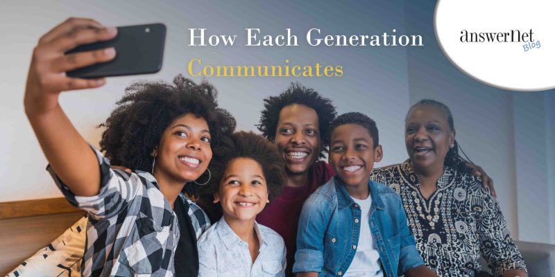 generation communication - family huddled together on couch with daughter holding phone for a picture