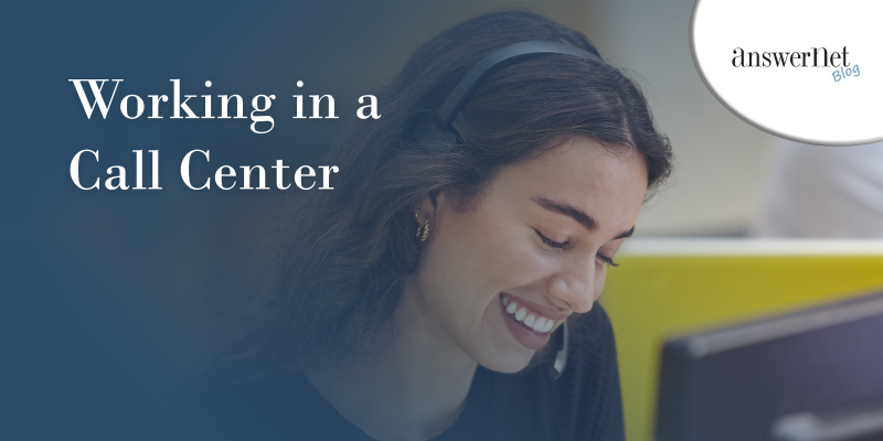 working in a call center; female call center agent smiles looking down at her computer screen